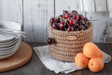 fruits and berries on the kitchen table in a knitted basket, zero waste kitchen storage, rustic...