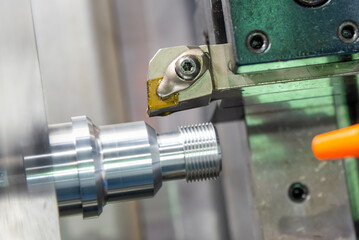 The  CNC lathe machine thread cutting at the end of metal stud parts. - obrazy, fototapety, plakaty