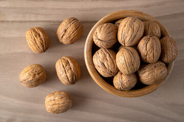Whole walnuts on wooden background
