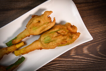 Stuffed zucchini flower on plate. High quality photo