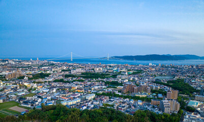 Fototapeta na wymiar Aerial view of Akashi City and Awaji Island with bridge in distance at blue hour