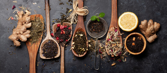 Various dried tea in wooden spoons