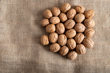 Whole shell walnuts on burlap sack,top view