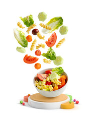 Pasta salad falling into a bowl isolated from the background with geometric shapes