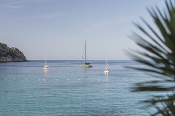 Yacht on the horizon, blue sea and sky. Minimalist film, simplicity, positivity.