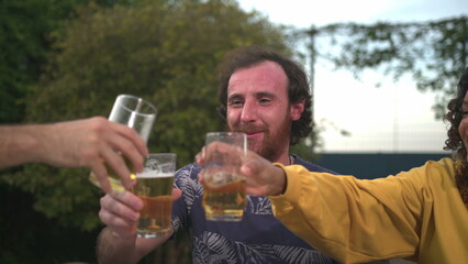 Diverse group of friends toasting celebration with drinks clinking beverages