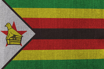 Patriotic classic denim background in colors of national flag. Zimbabwe