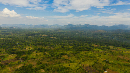 Aerial drone of Farmlands and villages in a valley among tropical vegetation and jungle. Sri Lanka.