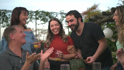 Father and son bonding celebration moment during family barbecue. Son serving meat to dad