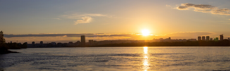 Panoramic view of summer golden sunset over Yenisei river in Krasnoyarsk, Russia