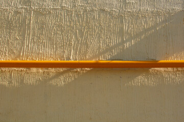 yellow pipe on the background of the yellow wall of the building