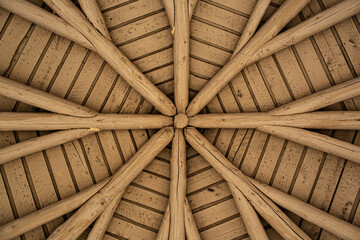 round wood timbered symmetrical ceiling