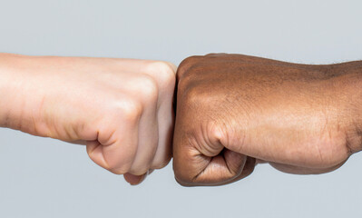 Black African American race male and woman hands giving a fist bump, multiracial diversity, immigration concept