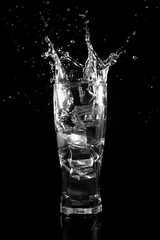 Water action spits out from a glass of water.