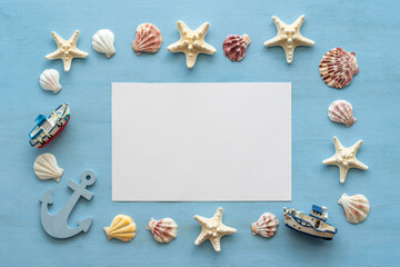 Obraz na płótnie Canvas Blank notebook paper, seashells, starfishes on blue wooden background.
