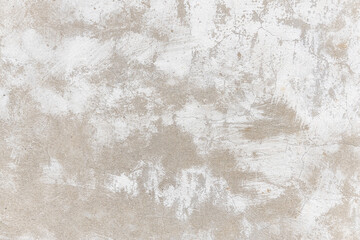 Old concrete wall in plaster with cracks and white paint.