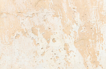 Old rustic uneven wall texture with paint that is chipping and peels off.