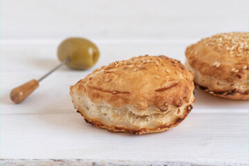 Israeli Savory Cheese Pastry Bourekas on white wooden background.