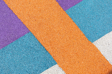 Special rubber coating for playground or sports activity. Junction of multicolored pieces of floor...