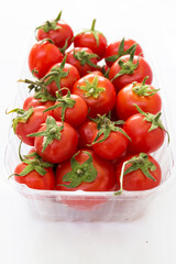 red tomato in a transparent container top view on a white background.  Design for supermarket advertising, banner, poster
