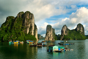 Floating fishing village and rock island in Halong Bay, Vietnam, Southeast Asia. UNESCO World...