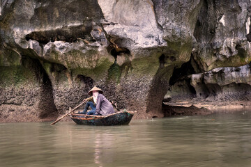 Local vietnamese in a canoe on a small river in the mekong delta ho chi minh city vietnam