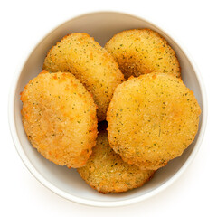 Fried breaded camembert nuggets with herbs in a white ceramic bowl on white from above.