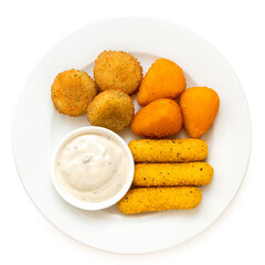 Fried breaded brie and camembert nuggets and mozzarella sticks on a white ceramic plate with white dip on white from above.