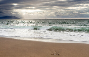 Fototapeta na wymiar Sunset at Azkorri beach in the coast of Biscay, Basque Country, north of Spain. 