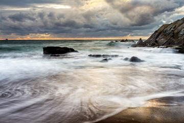 Obraz premium Sunset at Azkorri beach in the coast of Biscay, Basque Country, north of Spain. 