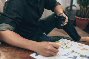 Travelers drink coffee while planning trips and writing pointing on map, or find travel routes. Travel concept.
