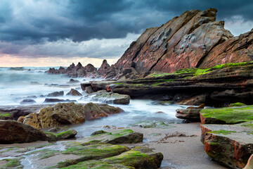 Obraz premium Sunset at Azkorri beach in the coast of Biscay, Basque Country, north of Spain. 