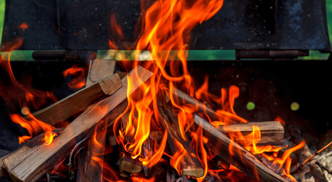 Orange flame when burning twigs and firewood in a barbecue