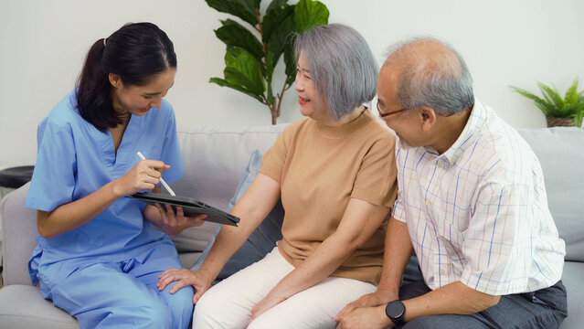 Asian senior grandparents feel cheerful after receiving good news about health problems from young nurse home care. The elderly couple have good health without disease after a medical examination.