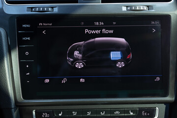 Close up shot of fully electric car dashboard trip computer display showing the status of the...