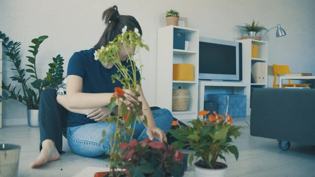 A Lesbian Couple Planting Flowers Together For Their Home.	