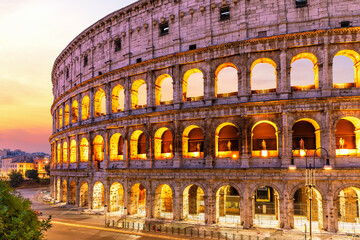 Illuminated Coliseum at sunrise beautiful side view, Rome, Italy