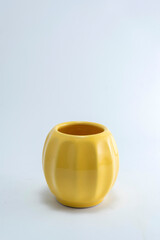 Handmade ceramic cups and bowls of many colors and shapes for tea, coffee and various infusions on a white and sparkling background