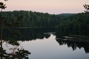 View of river from Parnas rock. Popular tourist route. Reflection of trees in water. Lake Yastrebinoe in summer, Republic of Karelia. The concept of traveling in Russia.