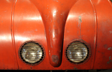 Fototapeta premium Retro car close up photo. Beautiful details of vintage auto. Headlight beam close up. 