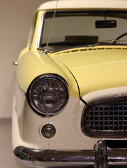 Retro car close up photo. Beautiful details of vintage auto. Headlight beam close up. 