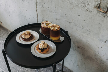 Dessert set of scones and americano coffee for couple served in cafe.