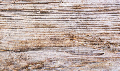 Wood texture background. Top view of a vintage wooden table with cracks. Light brown surface of old wood with knots in natural color