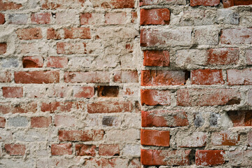 Minimalistic horizontal stone background. Corner of dilapidated building close up. Old brick wall with cement.