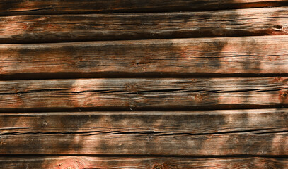 The wall of village house in close up. Old wooden wall cracked by time. Minimalistic brown...