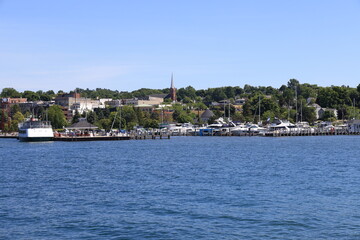 Fototapeta na wymiar The beautiful skyline of downtown Petoskey, Michigan with the marina and harbor in the summer.