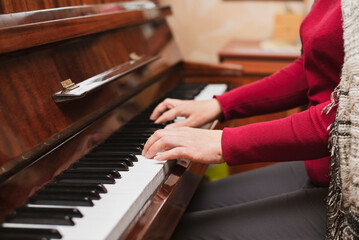 A woman plays the piano, remembers how she was once fond of music and studied to be a pianist at a...