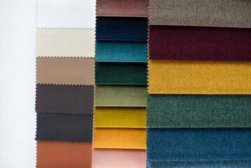Fabrics of different colors are compiled in the form of a catalog for choosing fabric for fabric blinds or upholstered furniture. Close up