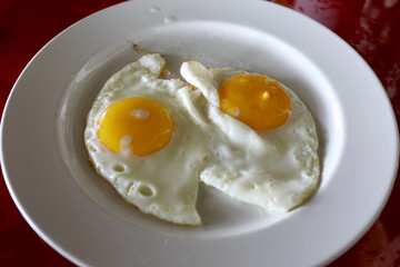 White plate with fried eggs