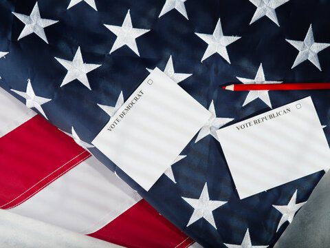 Parliamentary Elections. Democrats And Republicans. Two Sheets Of Paper And A Red Pencil On The Background Of The American Flag. Low Angle View. Freedom Of Choice, Patriotism.